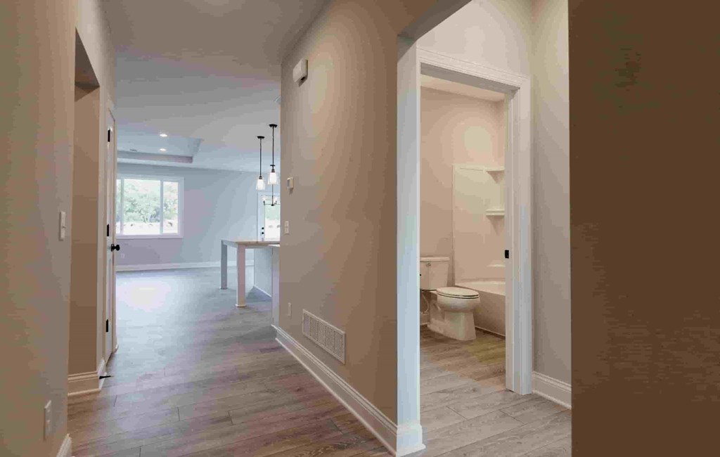 a large hallway with a bathroom and a toilet