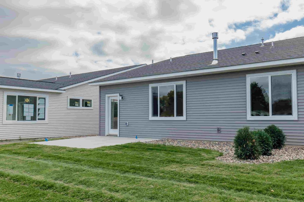 a blue house with a yard in front of it