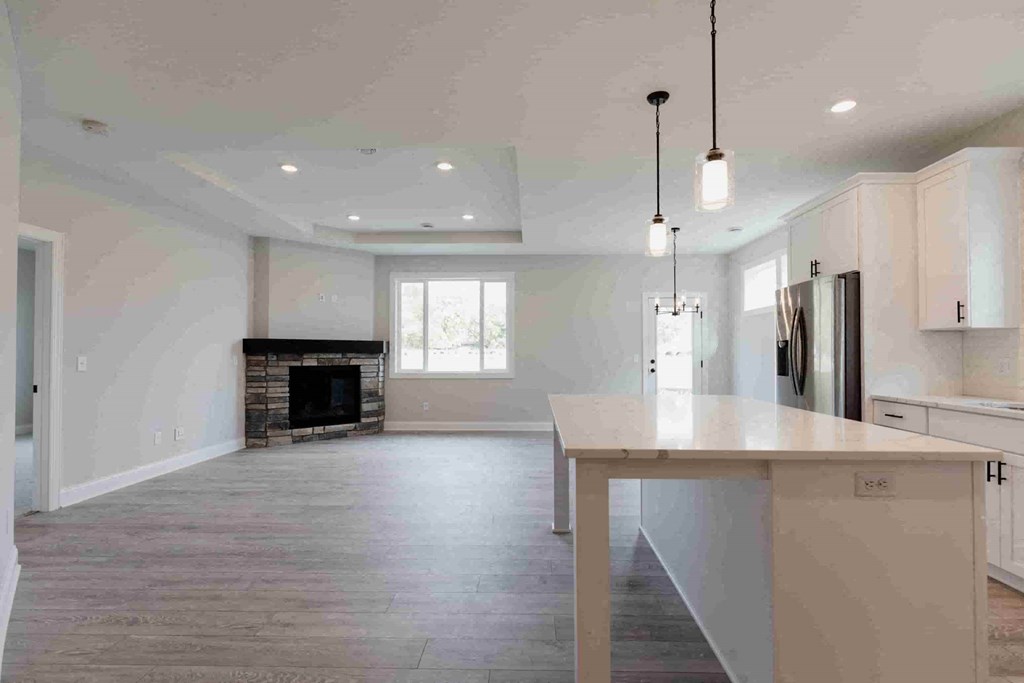 an empty kitchen and living room with a fireplace