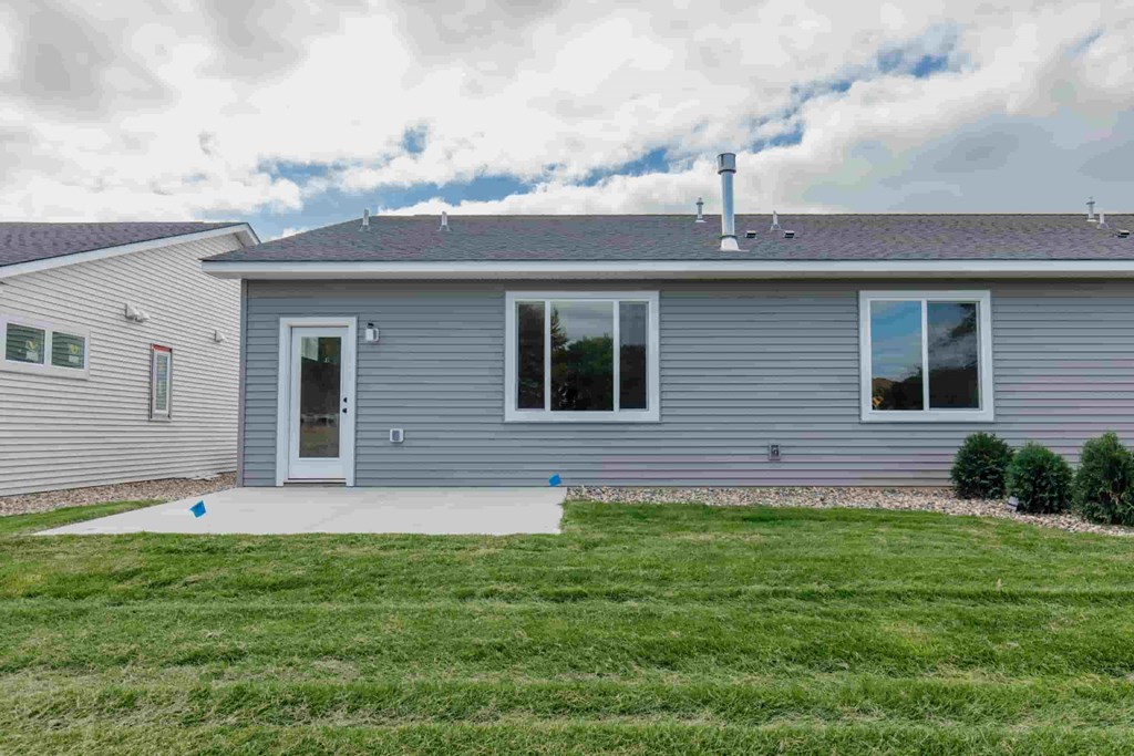 a blue house with a yard in front of it