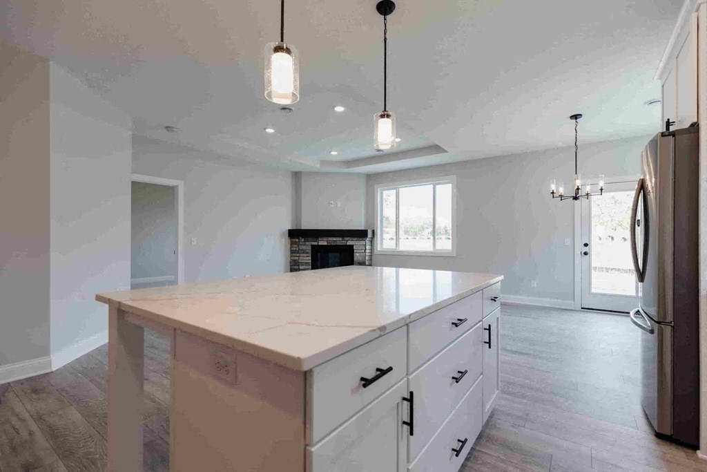 an empty kitchen with a large island in the middle