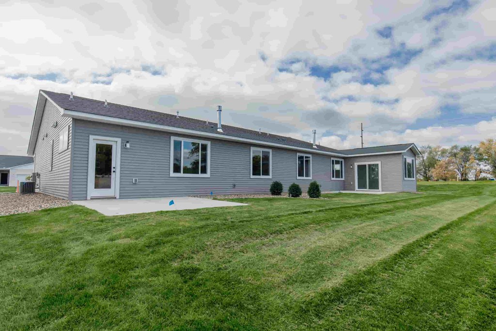a blue house with a yard in front of it