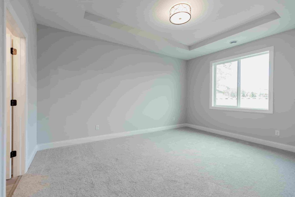 an empty room with white walls and a window