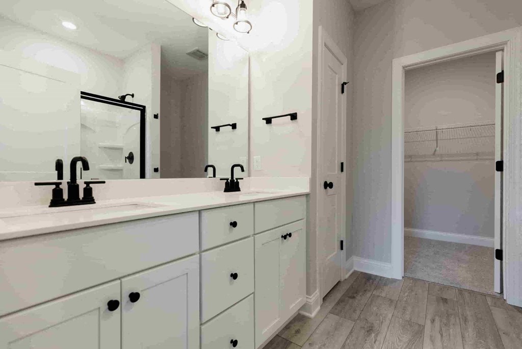 a bathroom with two sinks and a mirror