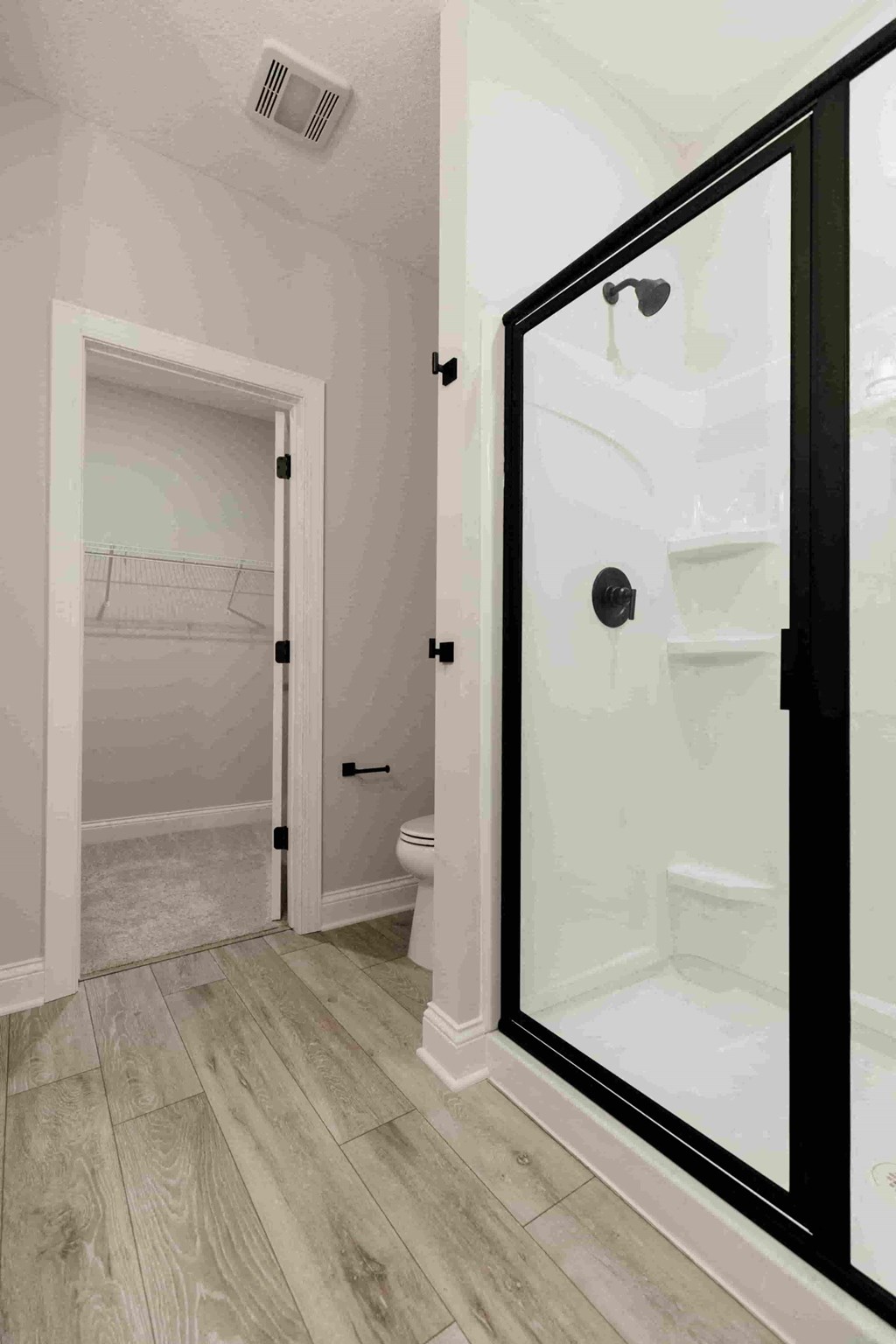 a bathroom with a shower with a glass door