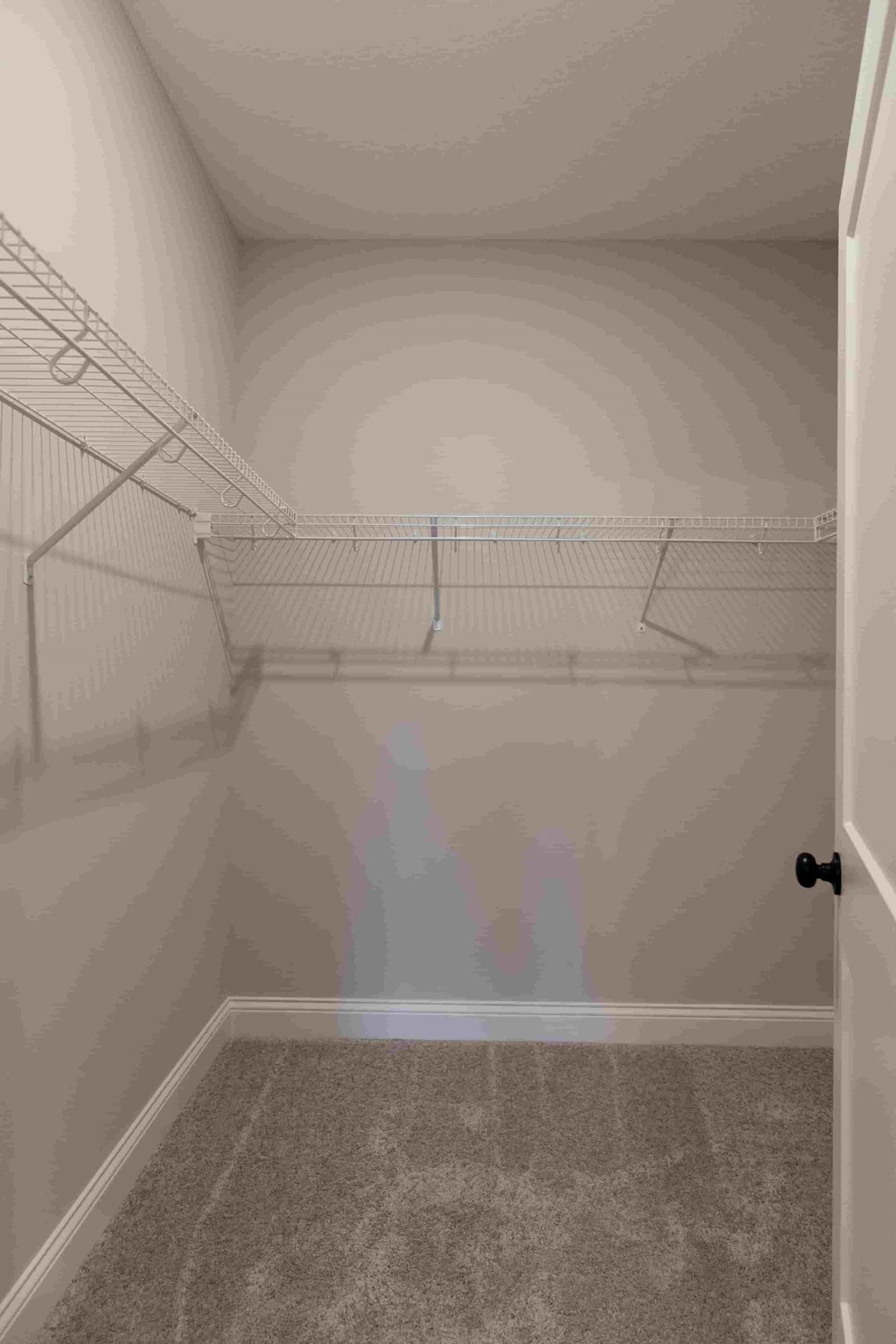 the spacious walk in closet in the master bedroom of a manufactured home