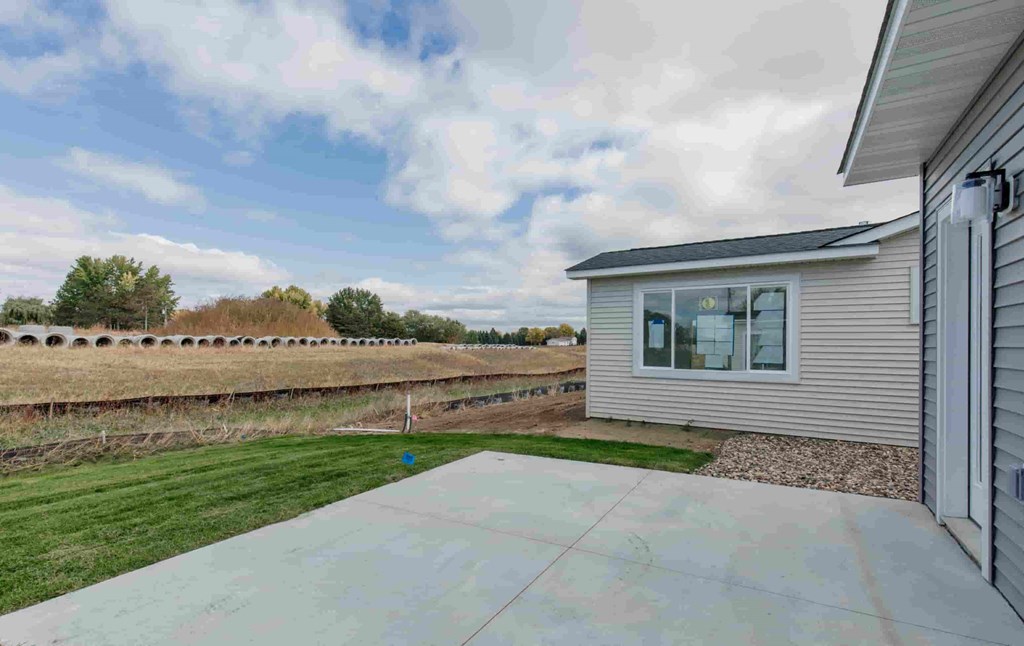 a view of the backyard from the driveway of a home