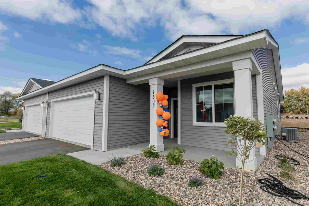 a with a garage and a yard with a pumpkin decoration