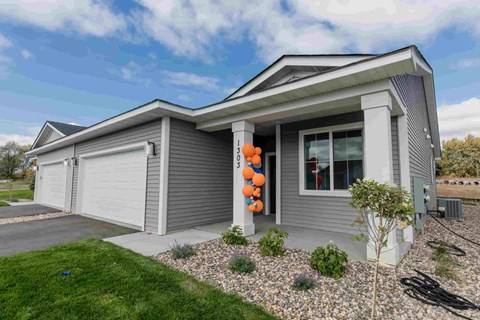 a with a garage and a yard with a pumpkin decoration