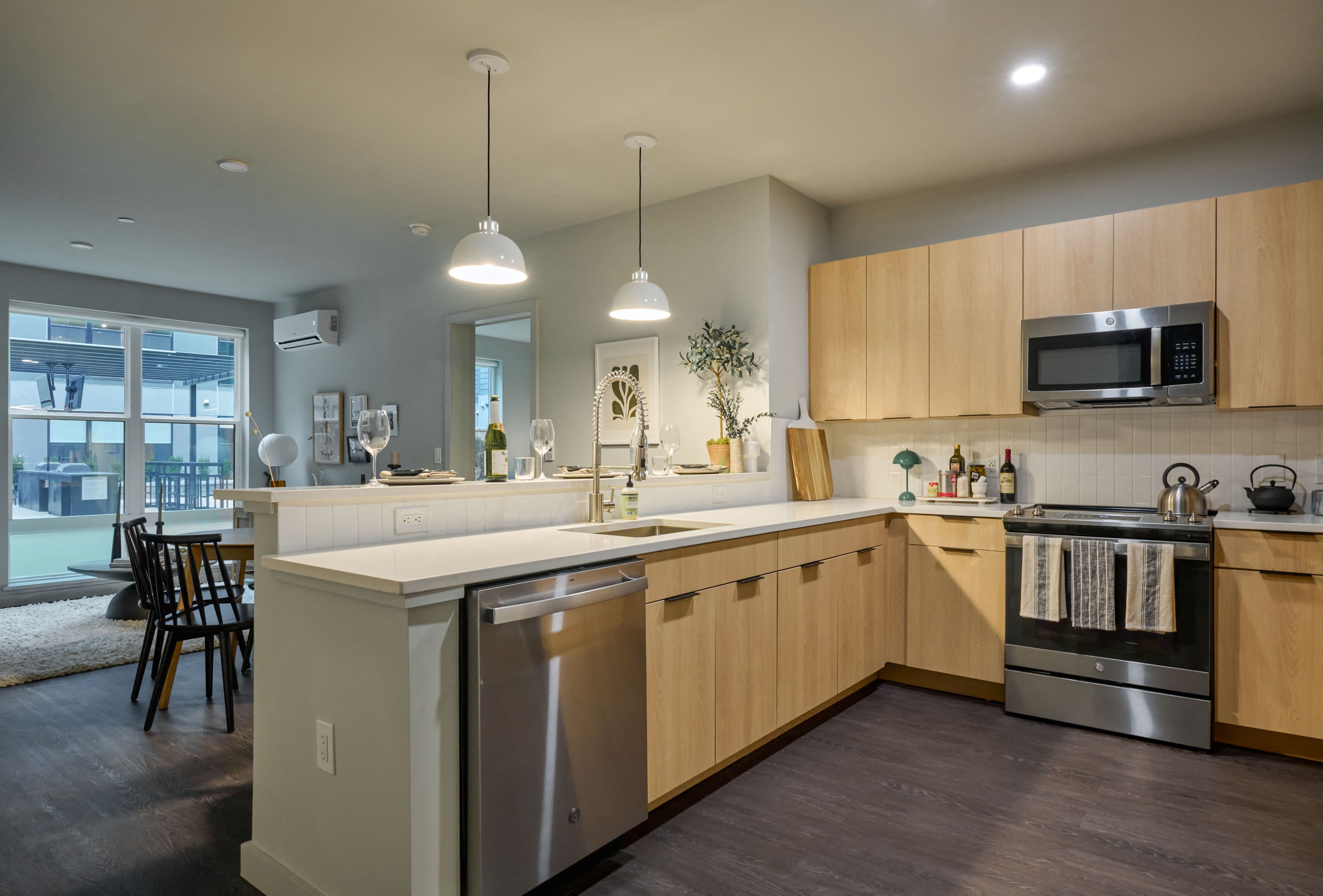 A modern kitchen with wooden cabinets and stainless steel appliances.