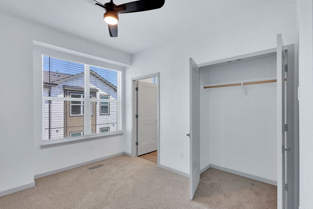 Bedroom on second floor with plush carpet, closet, large window and full bath