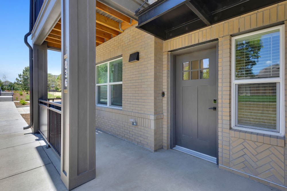 Entrance of townhome with windows, video doorbell and keyless entry
