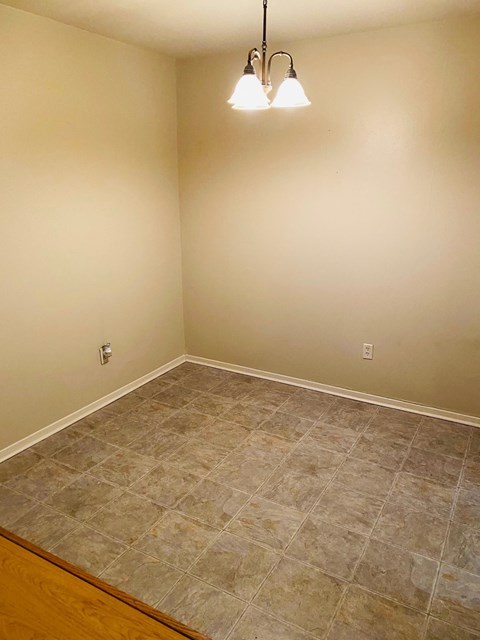 a empty room with a tiled floor and two lamps