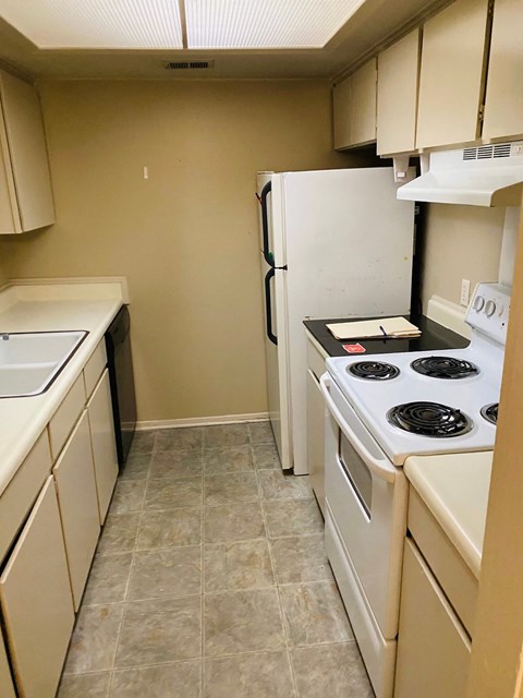 a kitchen with white appliances and a white refrigerator