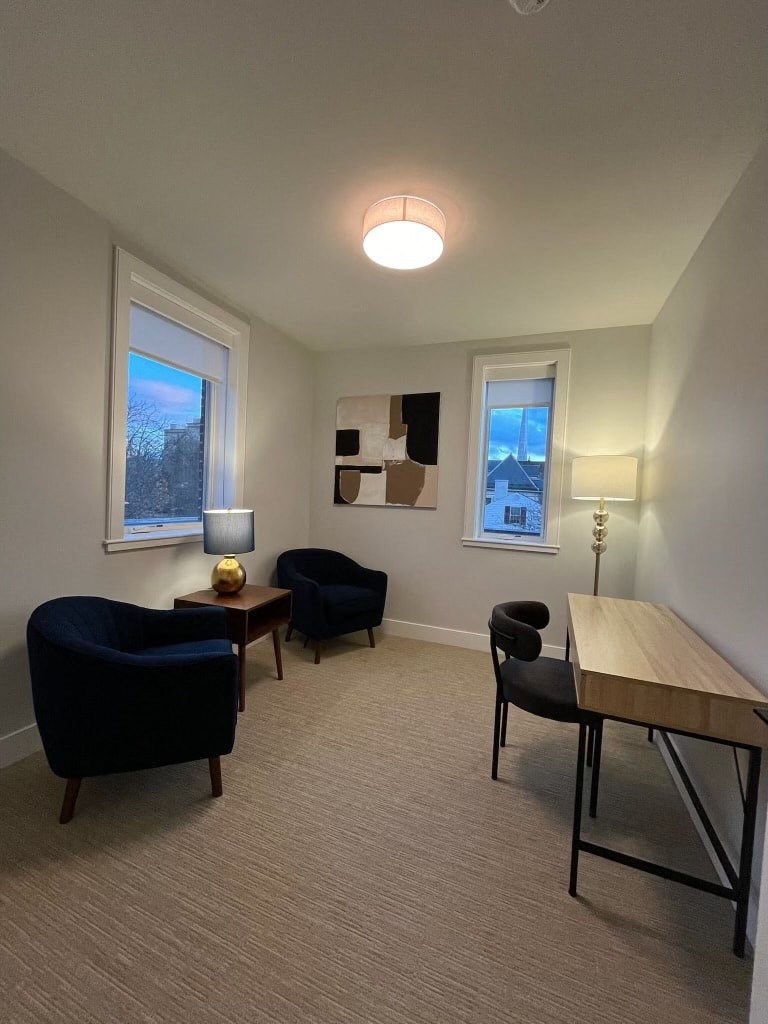 a living room with two chairs and a table