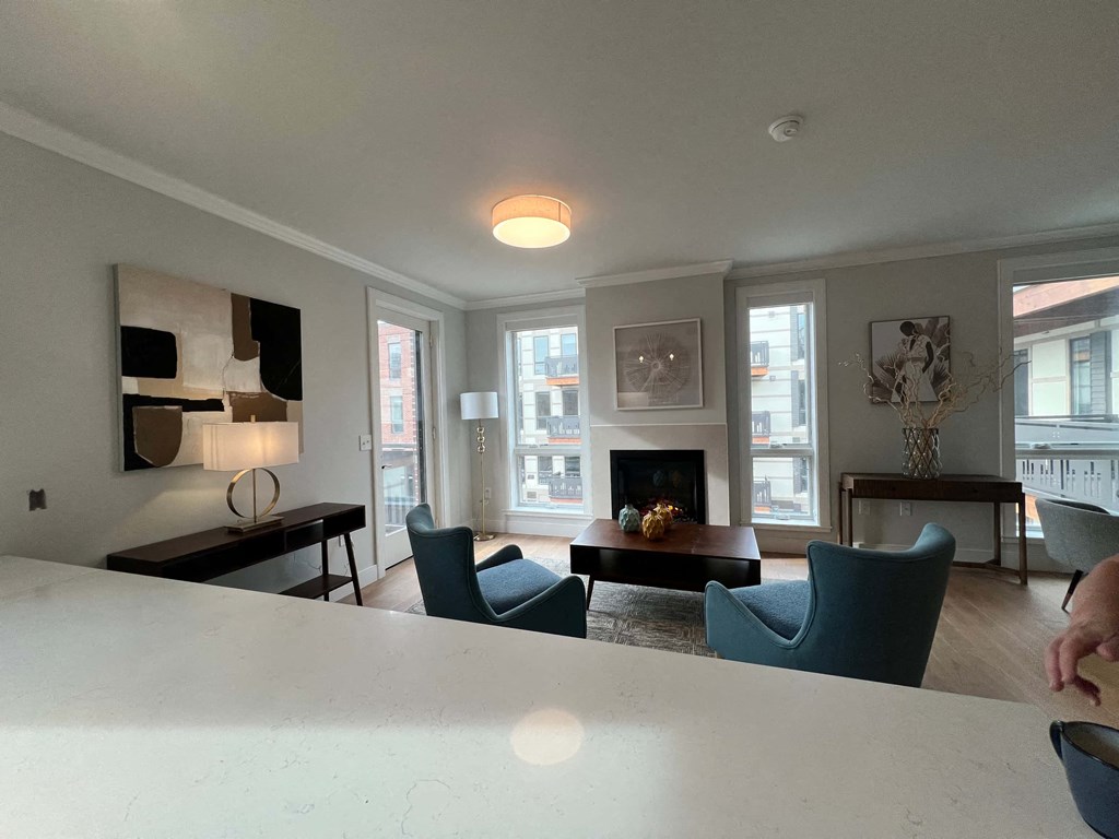 a living room with a table and chairs and a fireplace