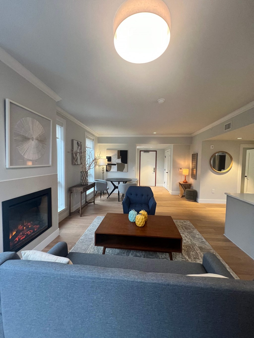 a living room with a couch and a coffee table and a fireplace