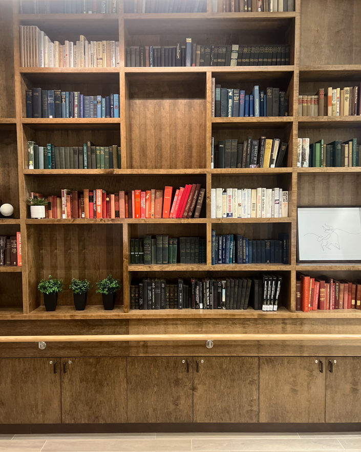 a library with wooden shelves filled with books