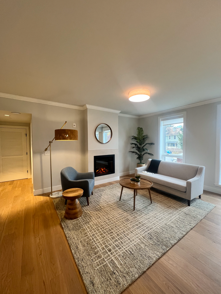 a living room with a couch and a chair and a fireplace