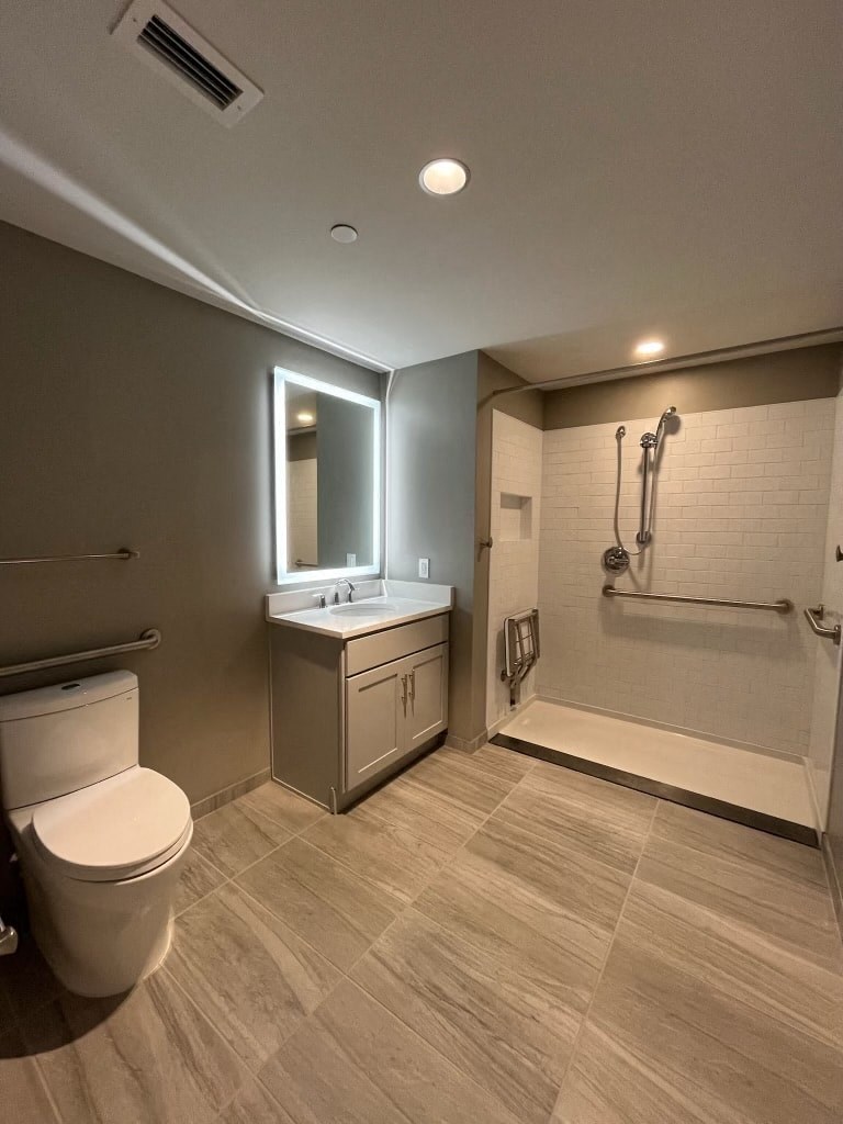 a bathroom with a toilet and a sink and a shower