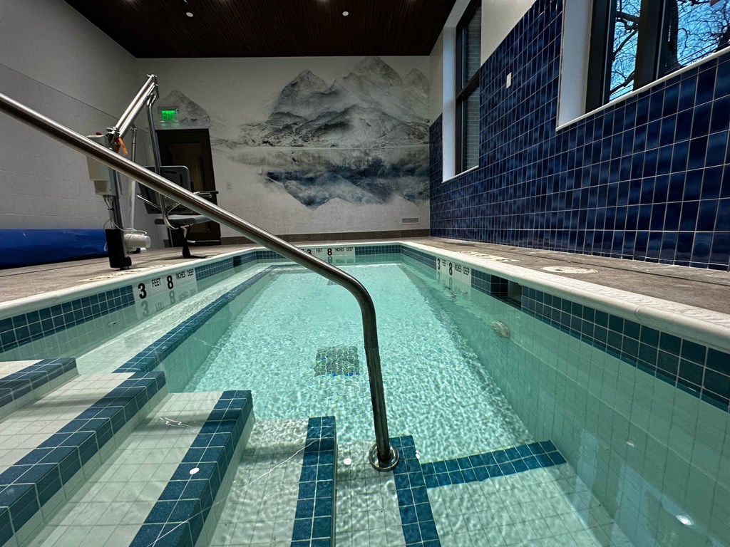 a swimming pool in a hotel with a rail in the water