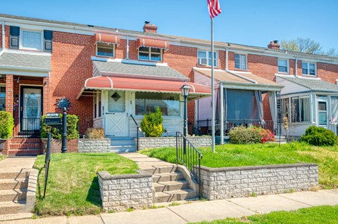 an old brick house with an flag in front of it