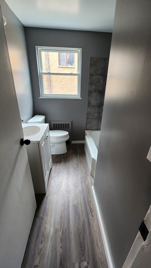 a small bathroom with a toilet and a sink and a window
