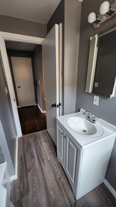 a small bathroom with a sink and a mirror