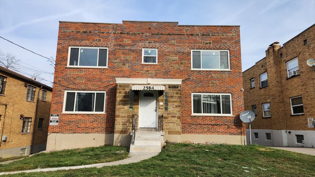 an old brick building with a white door and stairs