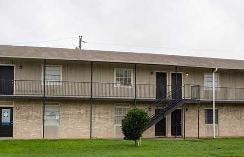 an apartment building with a balcony and a staircase