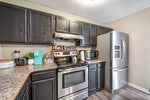 a kitchen with stainless steel appliances and granite counter tops