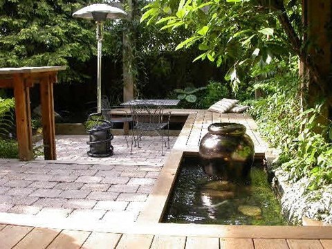 A small garden with a table and chairs.