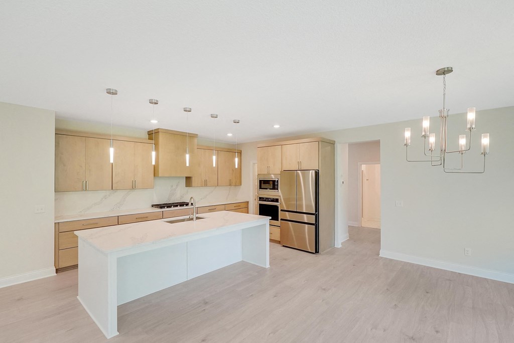 a kitchen with wooden cabinets and a white counter top