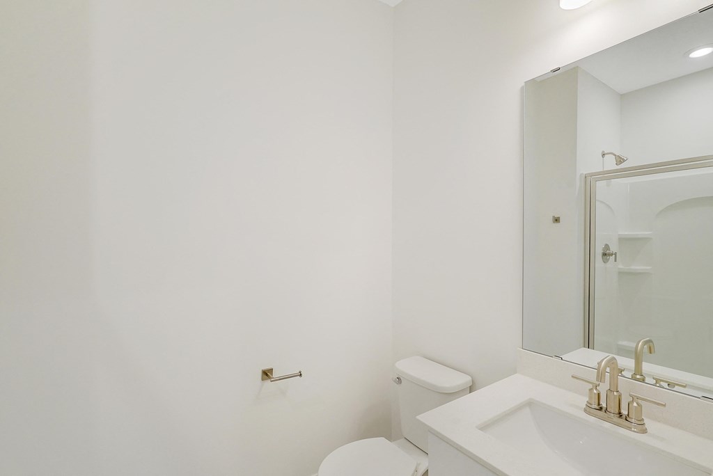 a bathroom with a toilet and a sink and a mirror