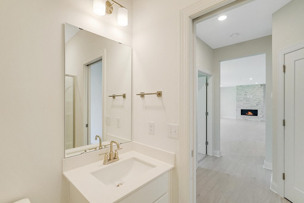 a white bathroom with a sink and a mirror