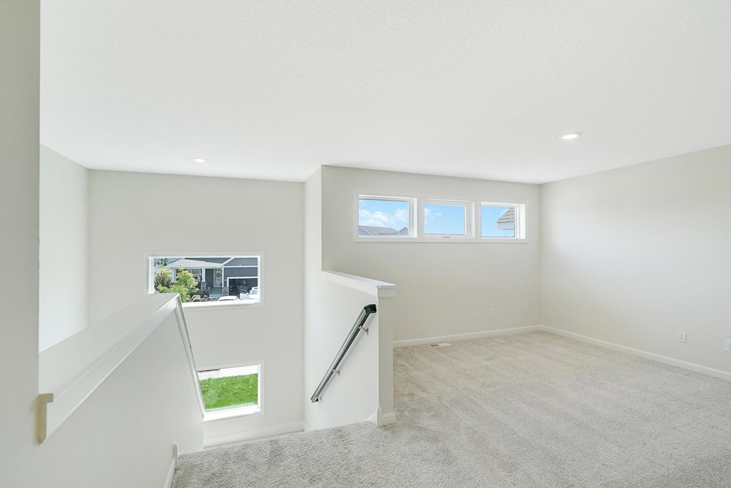 a white room with a staircase and a window