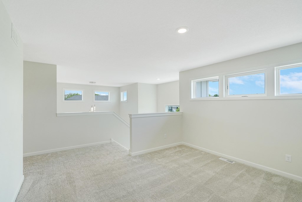 an empty room with a carpeted floor and a window