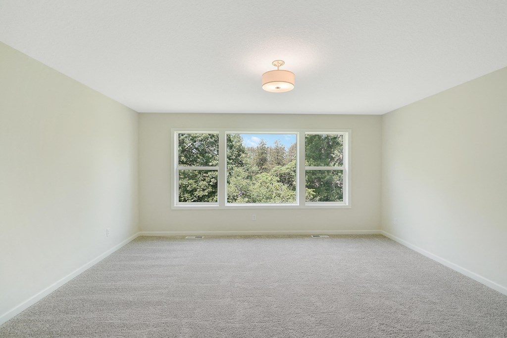 an empty living room with a large window