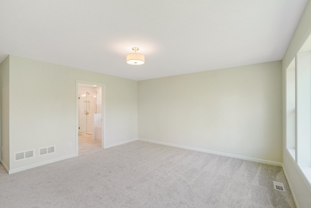 an empty living room with white walls and a white carpet