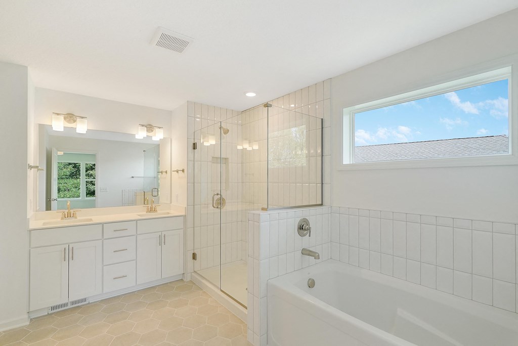 a bathroom with a tub and a shower and a sink