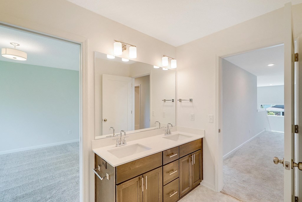a bathroom with a large mirror and a sink