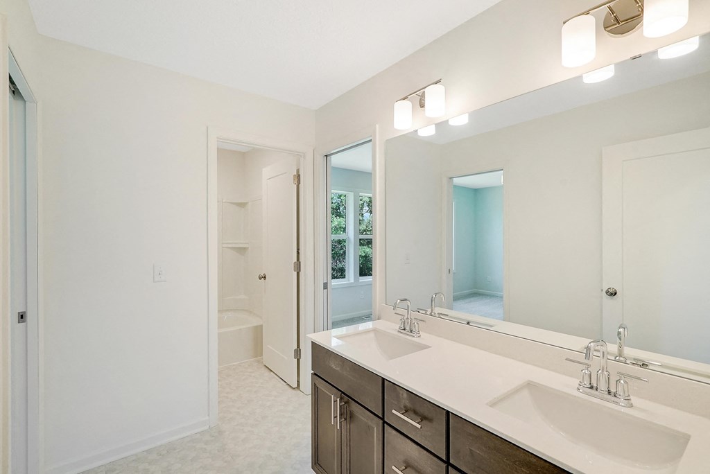a bathroom with two sinks and a large mirror