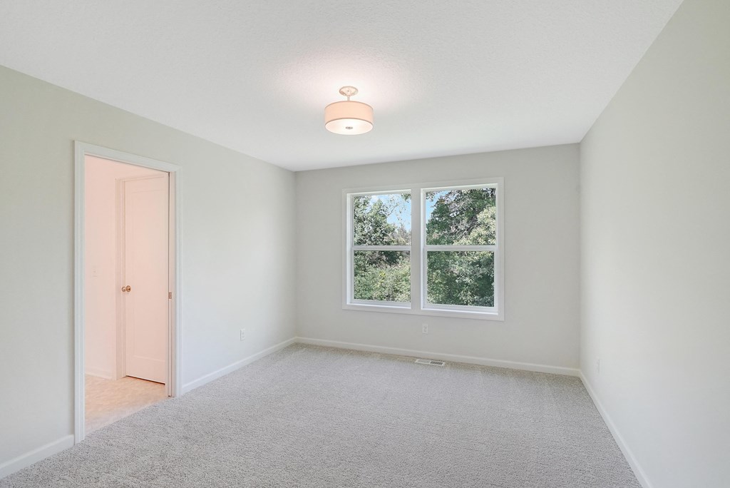 an empty room with a window and a door