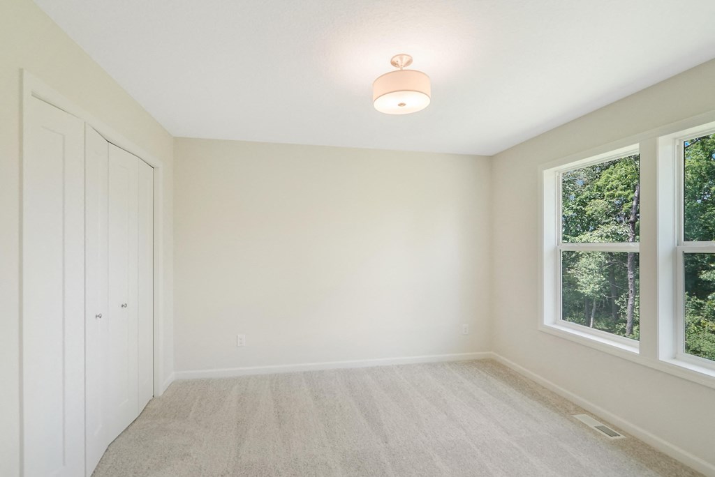 an empty room with two windows and a door