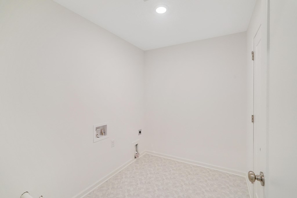 an empty room with white walls and a door