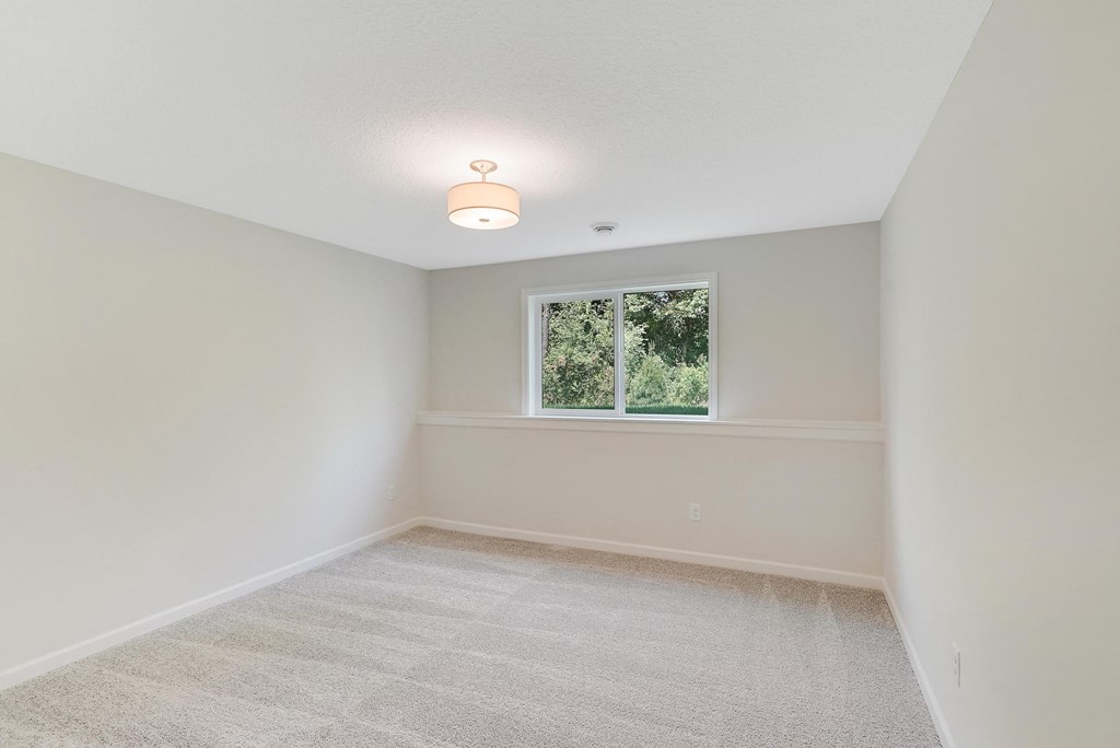 an empty room with white walls and a window
