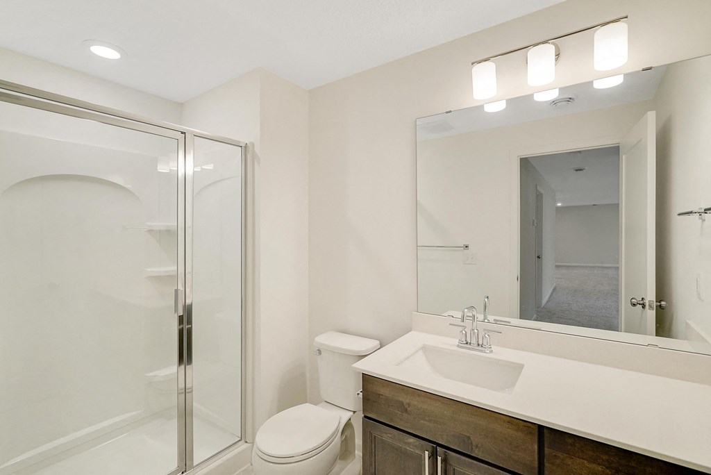 a bathroom with a sink toilet and a shower