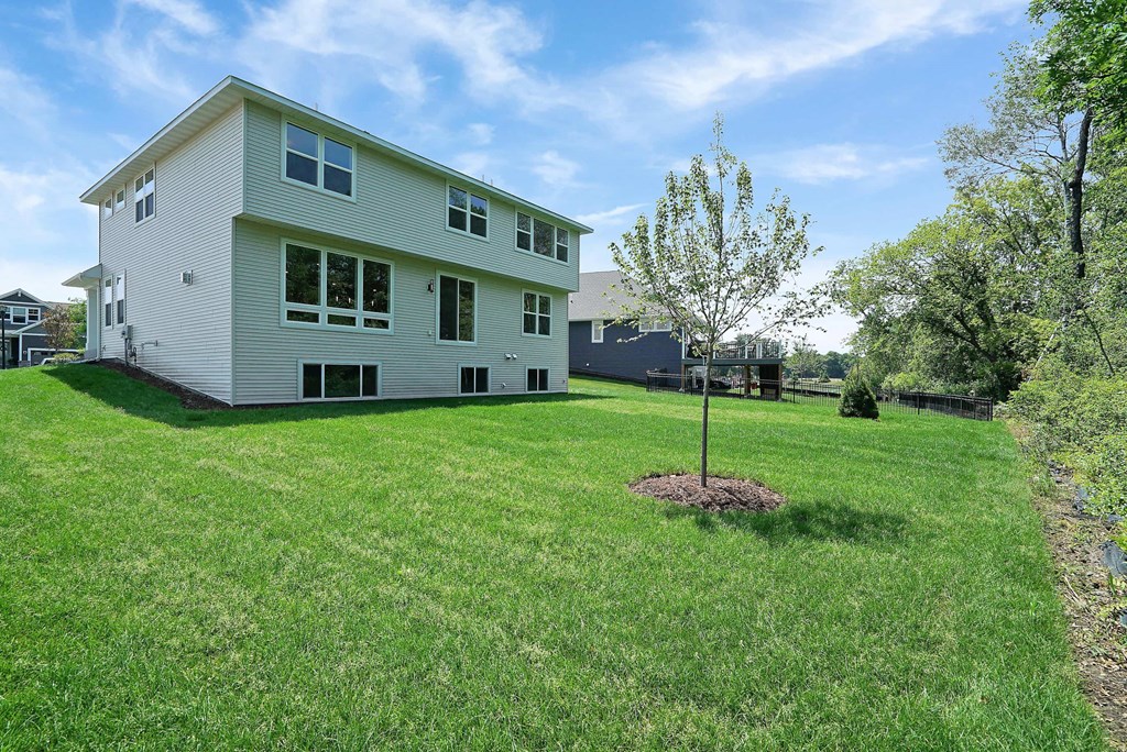 a white house with a yard and a tree