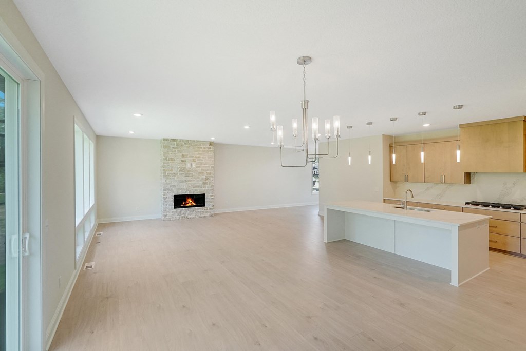 an open kitchen and living room with a fireplace