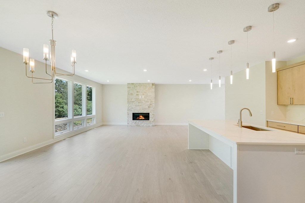 an open kitchen and living room with a fireplace